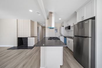 a renovated kitchen at Wescove Apartments with white cabinets and stainless steel appliances